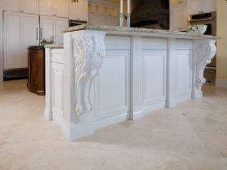 Traditional painted island cabinets with carved corbels