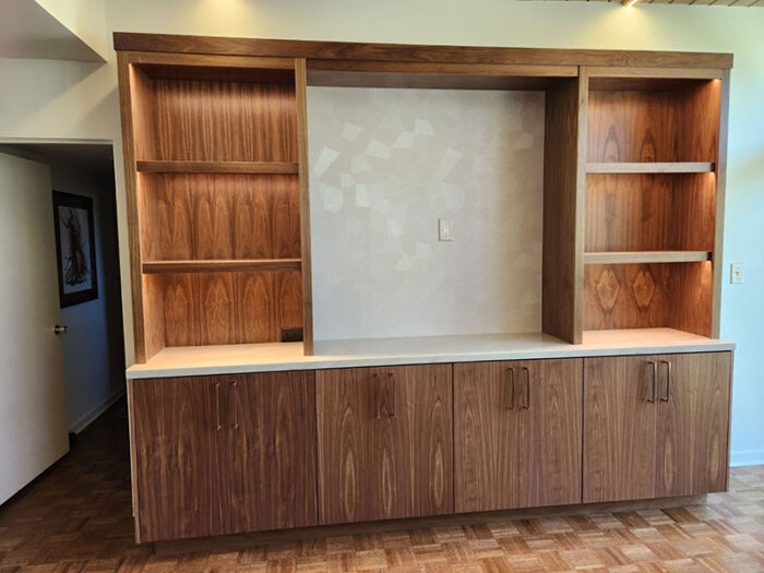 Familyroom cabinet done in a smooth slab walnut with a natural finish